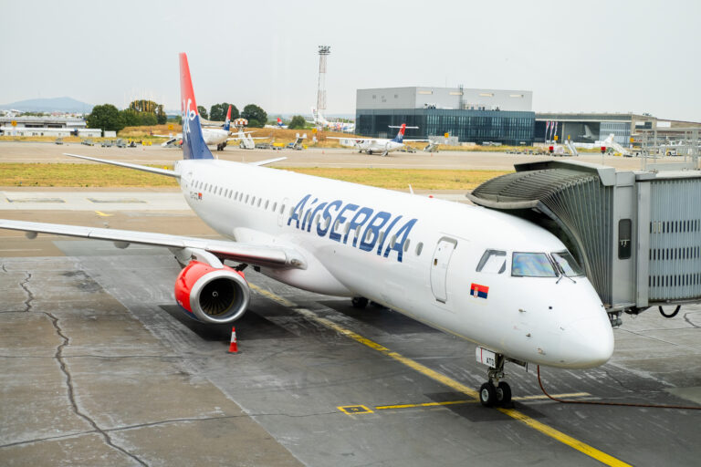 Air Serbia passenger aircraft parked at a terminal gate at Belgrade Nikola Tesla Airport